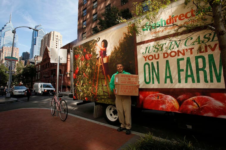 FreshDirect driver Cesar Soler delivers groceries to a house in Center City in 2018.