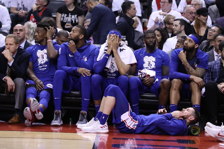 The dejected Sixers bench, including Tobias Harris (center), during their loss to the Raptors in Game 5 on Tuesday night.