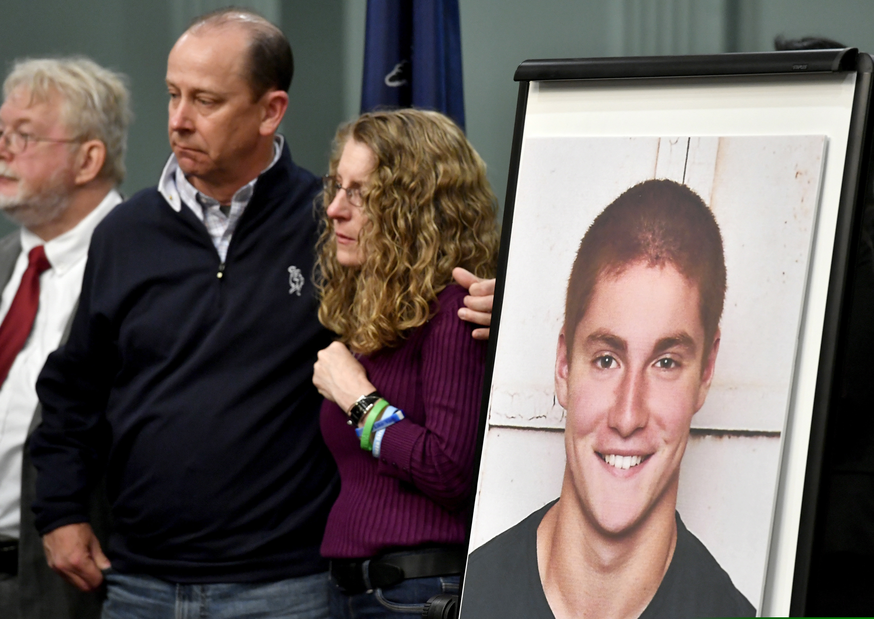 Jim and Evelyn Piazza, center, stand by as Centre County, Pa., prosecutors discuss an investigation into the death of their son Timothy Piazza, seen in photo at right, during a news conference in Bellefonte, Pa. in 2017.