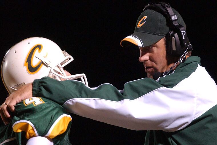 Doug Pederson talks to a player as head coach of Calvary Baptist.