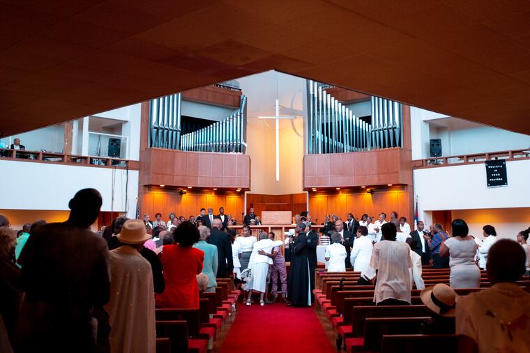 Worshipers gather at Zion Baptist Church, four days after a gunman shot six police officers in their Tioga neighborhood.