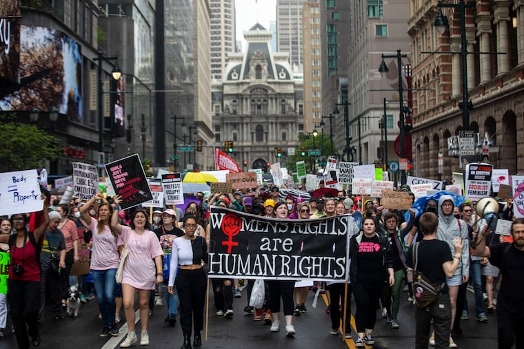 Many gather and march the streets of Center City for the City Women’s March rally along East Market Street in Philadelphia, on Saturday. The rally was part of a nationwide protest against the potential overturning of Roe v Wade.