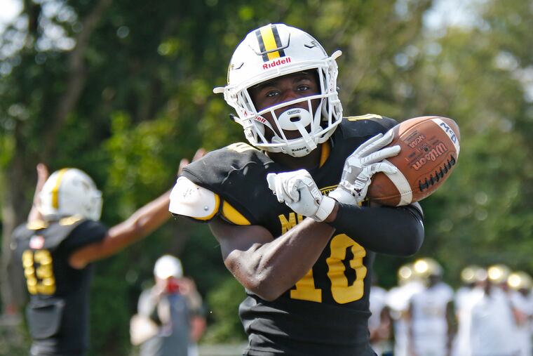 Bishop McDevitt running back Jon-Luke Peaker crosses his arms as he celebrates scoring a touchdown against Neumann-Goretti in the third quarter of a Catholic League Blue Division football game Saturday, Sept. 29, 2018, at Springfield Township.