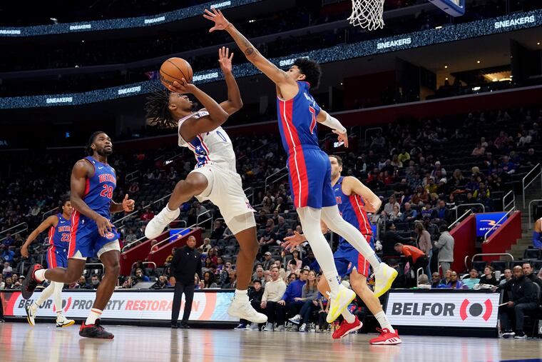 Philadelphia 76ers guard Tyrese Maxey (0) attempts a shot as Detroit Pistons guard Killian Hayes (7) defends during the first half of an NBA basketball game, Sunday, Jan. 8, 2023, in Detroit. (AP Photo/Carlos Osorio)