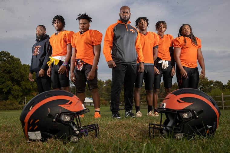 Chester High coach LaDontay Bell (center) and the captains of the football team visited Roxborough days after the shooting of Nicolas Elizalde. From left are assistant coach Dennis Shaw, Cymeer Brown, Noble Thompson, Bell, Colin Ferrell, Malachi Holmes, and Jabree Davis.
