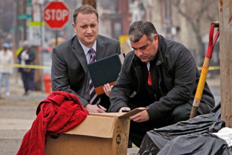 Philadelphia police investigate the box where a newborn was found outside a North Philadelphia day-care center. (Alejandro A. Alvarez / Staff Photographer)
