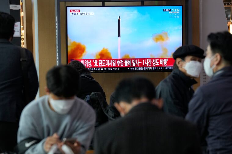 People watch a TV showing a file image of North Korea's missile launch during a news program at the Seoul Railway Station in Seoul, South Korea, on Thursday.