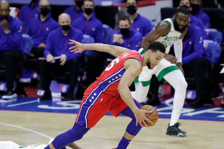 Sixers guard Ben Simmons steals the basketball from Boston Celtics guard Marcus Smart (on the floor) and guard Jaylen Brown during the first quarter on Friday.