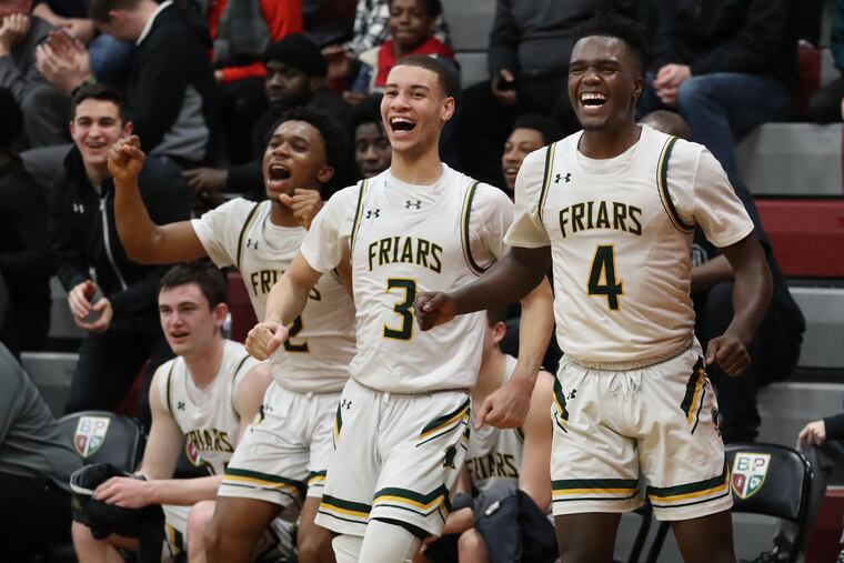 Oscar Uduma (left), Malik Edwards (center), and Donovan Rodriguez of Bonner-Prendergast celebrate in the final minute of their victory over Archbishop Ryan in Philadelphia Catholic League action.