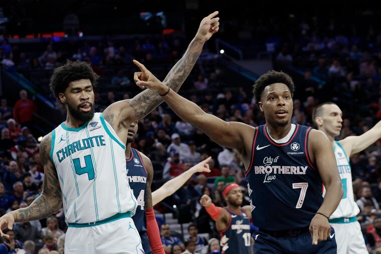 Charlotte’s Nick Richards (left) and the Sixers' Kyle Lowry tell the referee which way the ball should go during the game Saturday at the Wells Fargo Center.