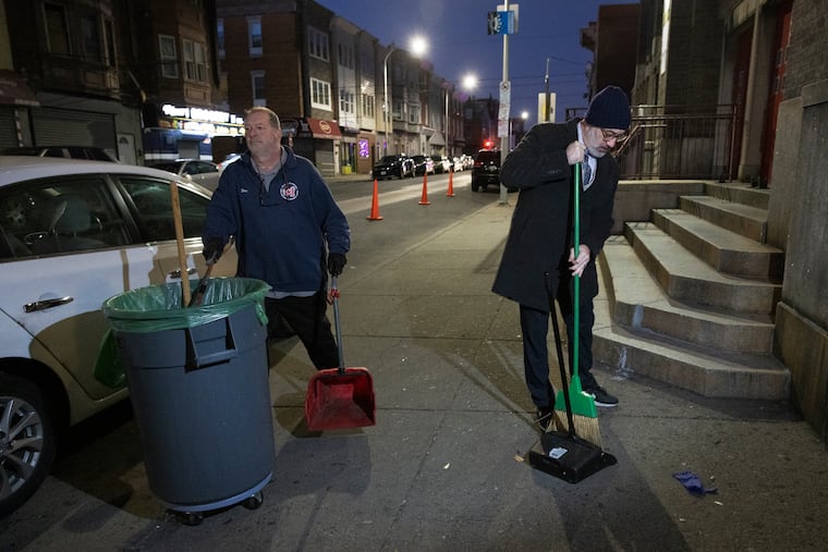 Principal David Lon and custodial assistant Joe Gallagher cleaned the sidewalks of trash and needles outside the school before students arrived on Dec. 14, 2022.