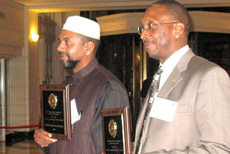 Malik Johnson (left) and brother Calvin received honors from the Philadelphia Commission on Human Relations. (Liz Gormisky / Staff Photographer)