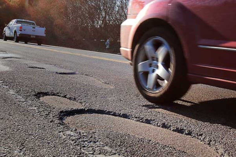 A car bounces through a series of potholes on Rt 352 in Gradyville Pa.