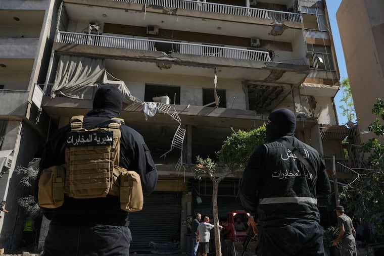 Members of the Lebanese Army Intelligence stand guard in front of an apartment that was struck in an Israeli airstrike in Dahiyeh, Beirut's southern suburbs, Lebanon, Sunday, June 14, 2026.