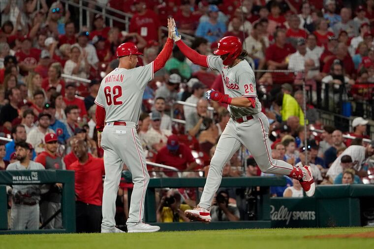 Philadelphia Phillies' Alec Bohm (28) is congratulated by third base coach Dusty Wathan after hitting a solo home run in the sixth inning against the St. Louis Cardinals on Friday in St. Louis. Bohm homered again two innings later.