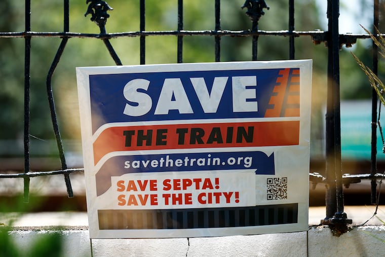 Signage reads “Save the train,” at the SEPTA train station on the Paoli/Thorndale Line on Monday, June 2, 2025 in Narberth, Pa.