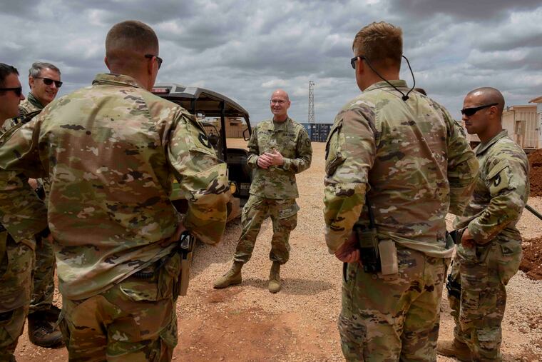 U.S. Army Brig. Gen. Damian T. Donahoe, deputy commanding general, Combined Joint Task Force - Horn of Africa, center, talks with service members during a battlefield circulation in September.