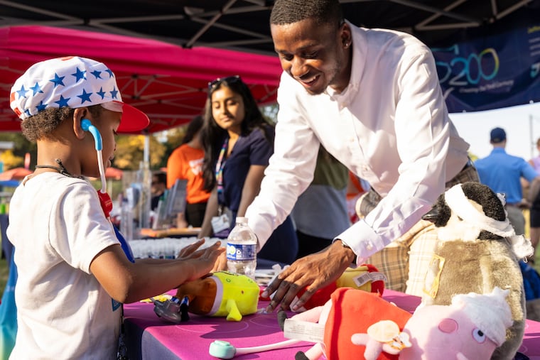 Kevin Carolina, a medical student, helps out at Jefferson Einstein Philadelphia Hospital Community Day in 2024. The event provided family fun, health screenings, and information about job opportunities at Jefferson Health.