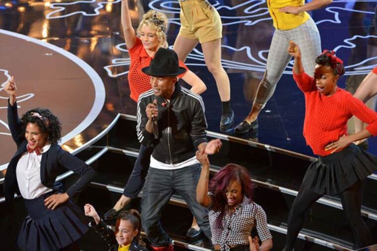 Pharrell Williams is surrounded by dancers as he performs 'Happy' during the awards program.