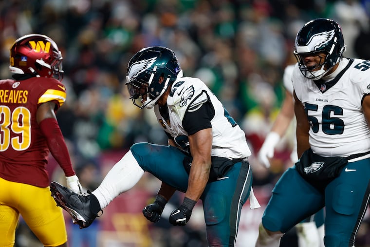 Eagles running back Saquon Barkley celebrates his fourth quarter touchdown against the Commanders on Dec. 20.