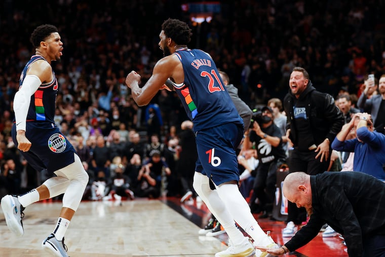 Sixers center Joel Embiid celebrates his the game winning overtime three-point basket with teammate forward Tobias Harris against the Toronto Raptors during game three of the first-round Eastern Conference playoffs on Wednesday, April 20, 2022 in Toronto.
