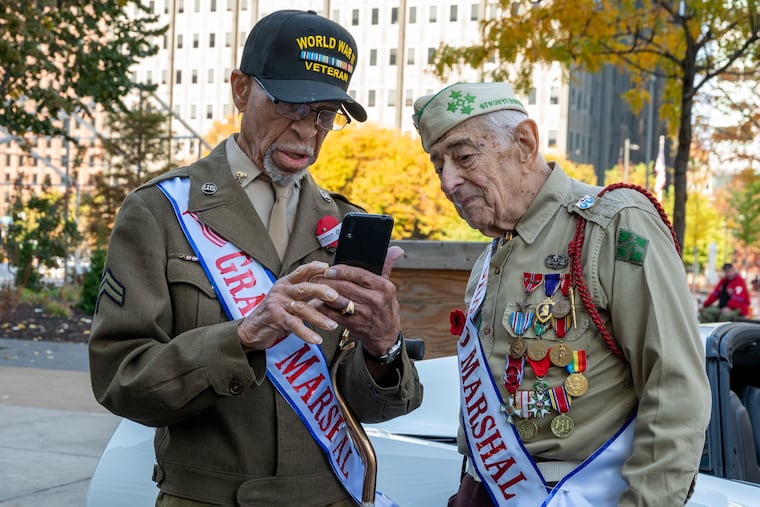 WWII veterans Corporal Benjamin Berry (left), who turned 100 in September 2023, and Pfc. Jake Ruser (right), who turned 99 in December 2023, check out their selfie before the start of Philadelphia Veterans Parade on Nov. 5, 2023, where they served as co-grand marshals.