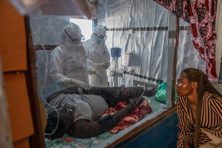 Health workers tend to an Ebola patient at the Rwampara Treatment Center in Ituri, Congo, Thursday, June 18, 2026.