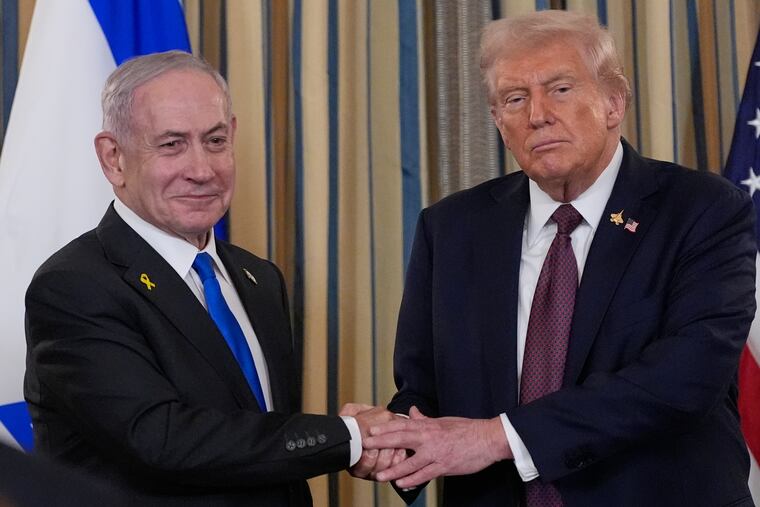 Israel's Prime Minister Benjamin Netanyahu shakes hands with President Donald Trump.