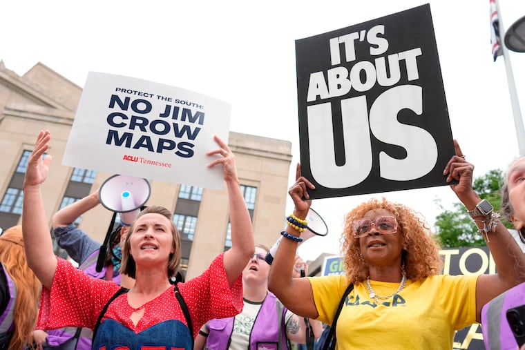 Mandy Cook, left, and Cheryl Woodard, hold signs during a rally against a special session of the state legislature to redraw U.S. Congressional voting maps Tuesday, May 5, 2026, in Nashville, Tenn.