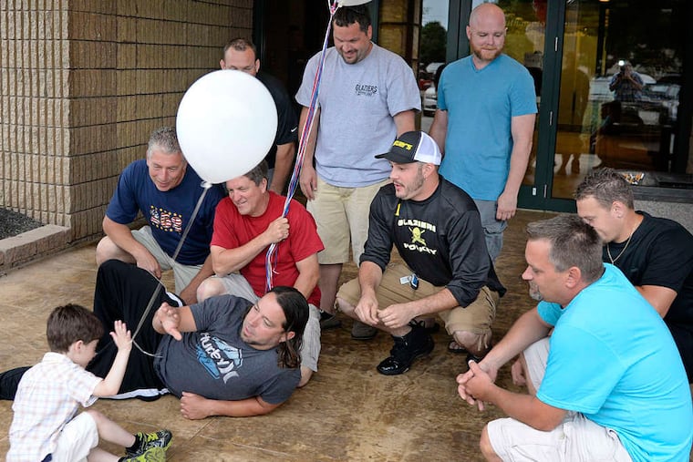 Alfonso "Fonzie" Soglia made pals with members of the local Glaziers Union. Here, his buddies try to talk him into mugging for a group photo. TOM GRALISH / STAFF PHOTOGRAPHER