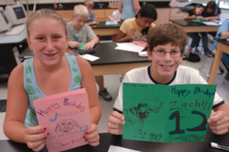 Sixth graders Julia Dintino and Michael Ottino, both 11, show off birthday cards they made for new classmates as part of an exercise in Transformation and Discovery period. Julia said she thought the project was a great idea.