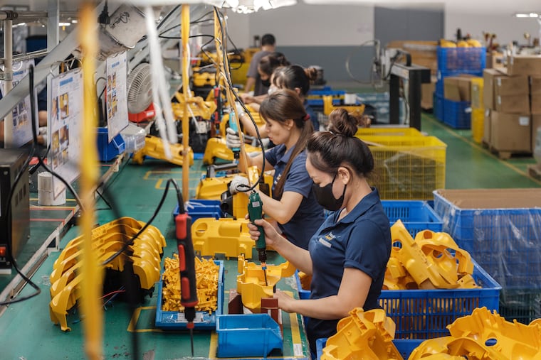 Workers assemble vacuum cleaners at a Techcom Industry factory on the outskirts of Hanoi, Vietnam, on May 29.