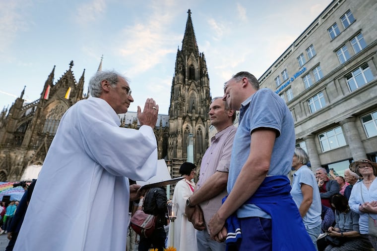 Same-sex couples take part in a public blessing ceremony in front of the Cologne Cathedral in Cologne, Germany, on Sept. 20, 2023.
