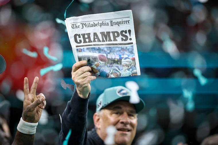 Philadelphia Eagles defensive coordinator Vic Fangio hold up a copy of The Philadelphia Inquirer after they defeat the Kansas City Chiefs in the NFL Super Bowl LIX game Sunday, Feb. 9, 2025, in New Orleans. Eagles win 40-22 over the Chiefs.