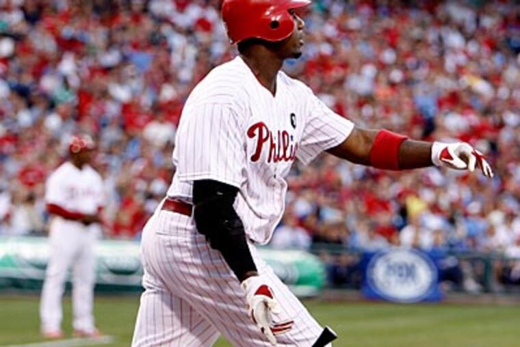 Ryan Howard watches the flight of his second inning home run against the Rangers' Colby Lewis. (Ron Cortes/Staff Photographer)