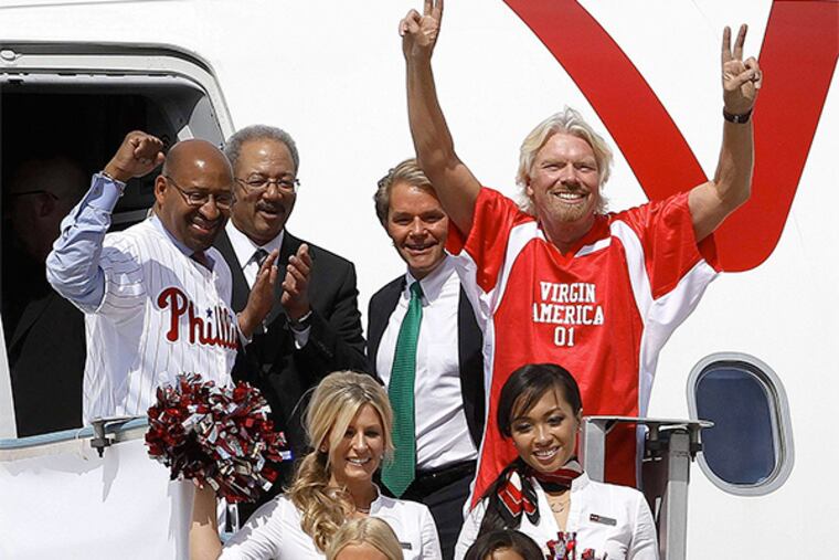 Among those heralding Virgin America’s arrival in Philadelphia in April 2012, were (from left) Mayor Nutter, Rep. Chaka Fattah, Virgin America president and CEO David Cush, and Virgin Group founder Richard Branson. The airline is now pulling out.
