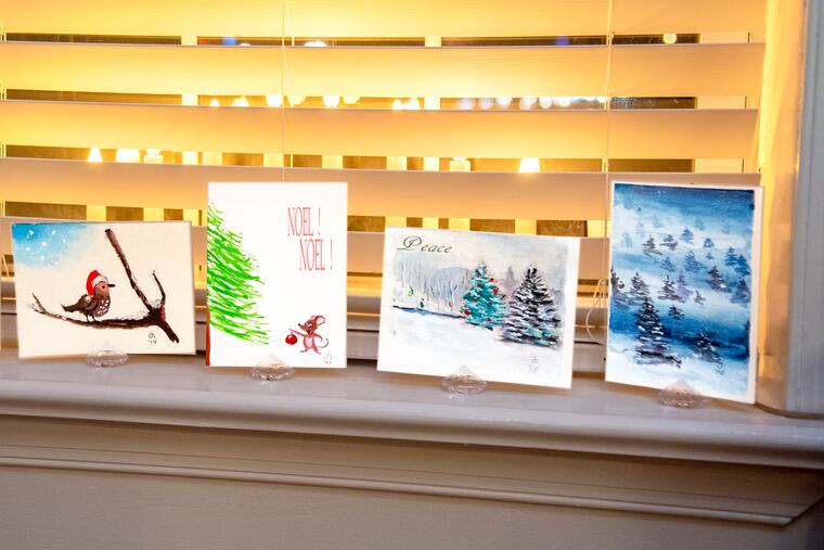 Christmas cards are displayed on a window ledge in the living room of the Pennsport rowhouse of Michael Oscapinski in 2022. They were handprinted and sent by longtime friends.