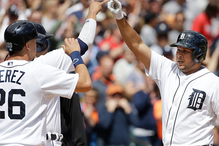 The Tigers' Jhonny Peralta is congratulated at home after hitting a grand slam during the sixth inning. (Carlos Osorio/AP)