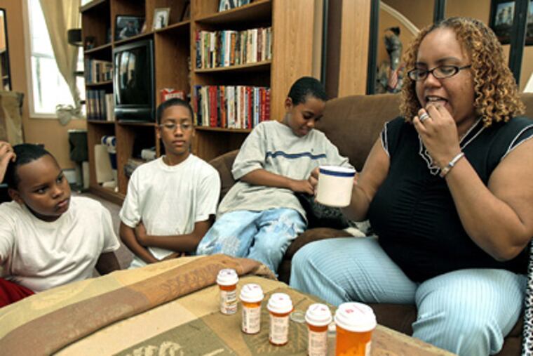 Charmaine Humphrey, who is uninsured and takes six medications daily, is on the waiting list for adultBasic. With her are (from left) son Qu-Ran Mosley, 11; nephew Jaime Galarza, 14, and son Danny Allen Jr., 9. (Akira Suwa / Staff Photographer)