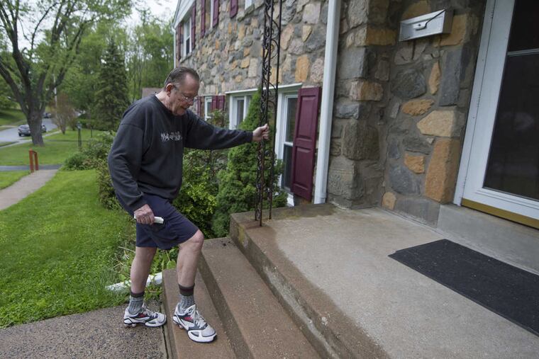 Bill Lyon maneuvers the steps in front of his Broomall home, which his family has sold and will soon be leaving.
