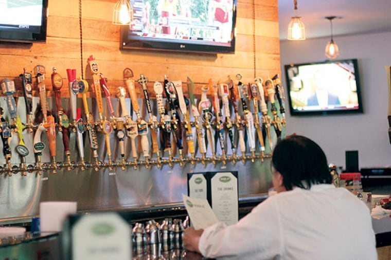 BarLy, a sports bar, offers an astonishing 60 beers on tap in Chinatown. ( MICHAEL KLEIN / Staff )