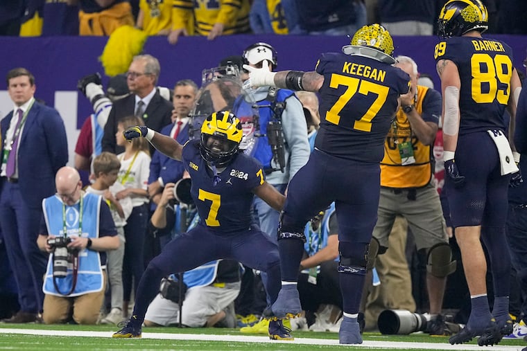 Michigan running back Donovan Edwards celebrates after scoring against Washington during the first half Monday.