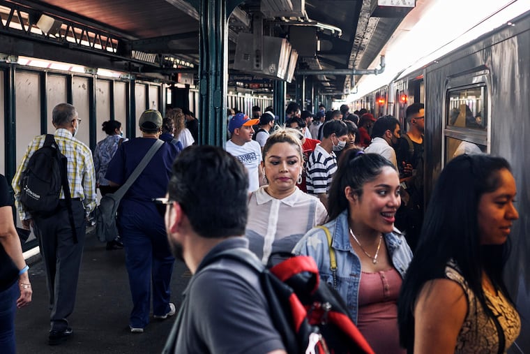 Commuters board the subway in New York, which still requires masks on trains and indoor stations.