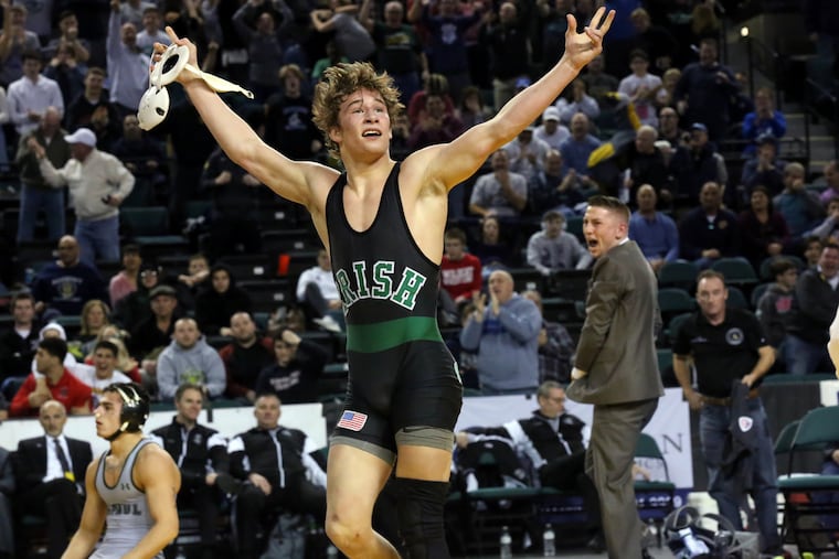 Lucas Revano, of Camden Catholic, celebrates after defeating Ricky Cabanillas, of DePaul, in the 145-pound class championship.