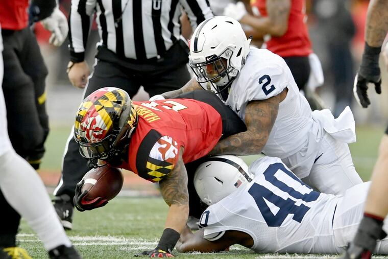 Penn State safety Marcus Allen (2) and linebacker Jason Cabinda (40) stop Maryland running back Lorenzo Harrison III.