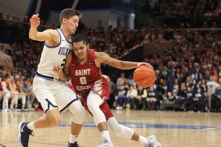 Lamarr Kimble (right) tries to drive past Villanova's Collin Gillespie during a Hawks non-conference loss earlier this month.