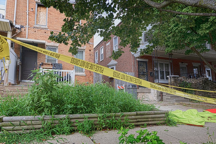 Police tape extends over the entrance of the home of Eugene Albert Horsch on West Chew Avenue in the Olney section of Philadelphia.