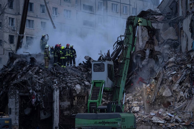 Rescue teams clear rubble from an apartment building that was destroyed in a Russian rocket attack in the city of Dnipro, Ukraine, Sunday. The death toll from the strike rose to 45 Tuesday, as first responders scrambled to pull survivors from the rubble.