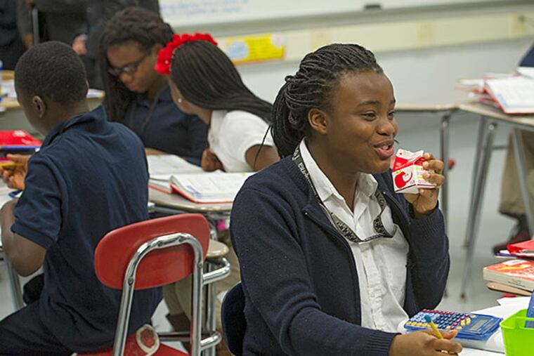 At Penn Wood Middle School in Darby Borough, Annikay Meade drinks apple juice after having breakfast at her desk. Serving the meal in class has enabled 80% participation in the program. CLEM MURRAY / Staff Photographer
