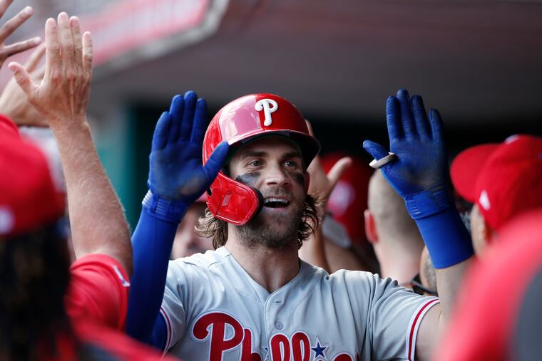 Bryce Harper celebrates his two-run home run during the eighth inning of the Phillies' win against the Cincinnati Reds on Monday afternoon.